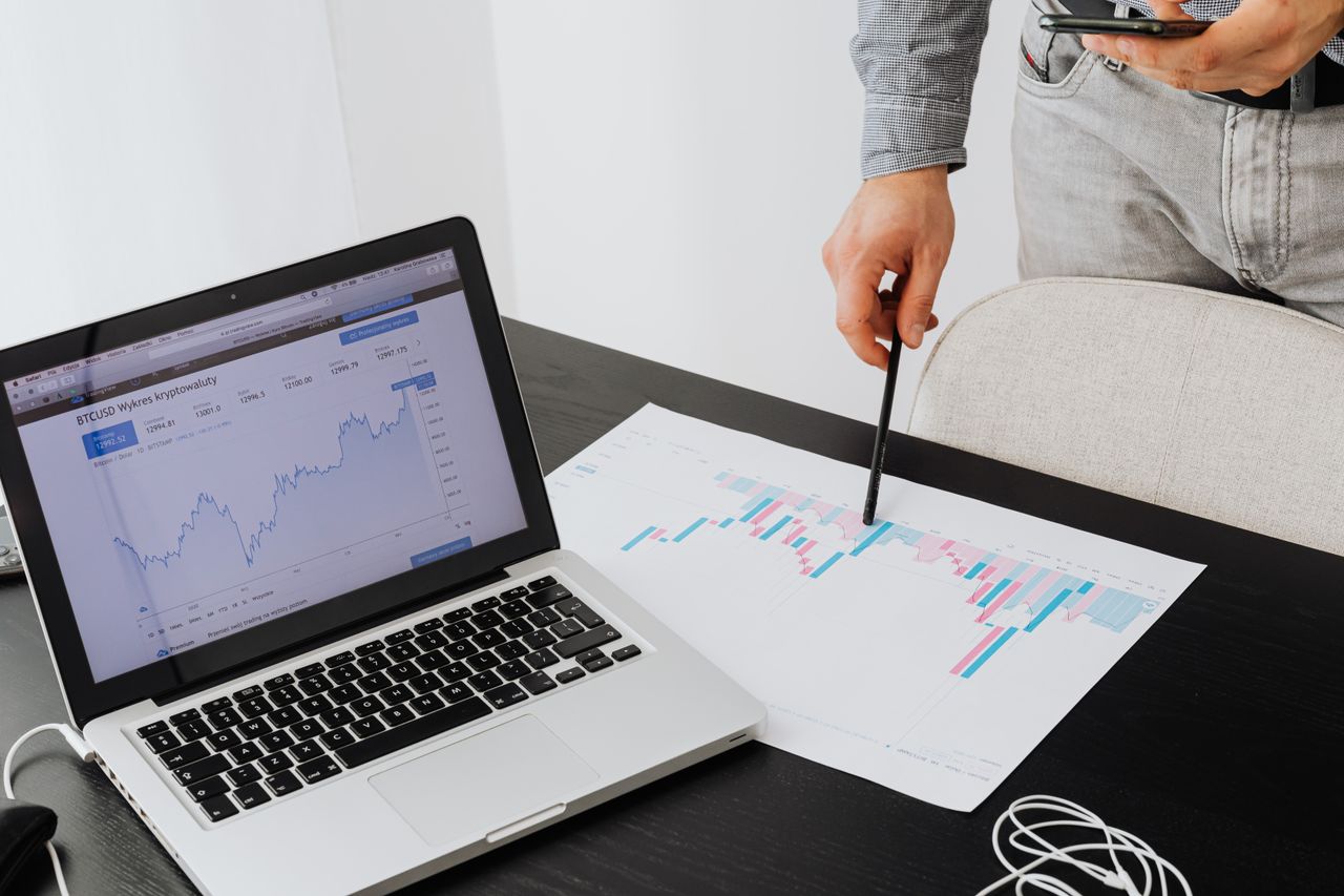 Home Person analyzing cryptocurrency data using a laptop, highlighting financial insights.