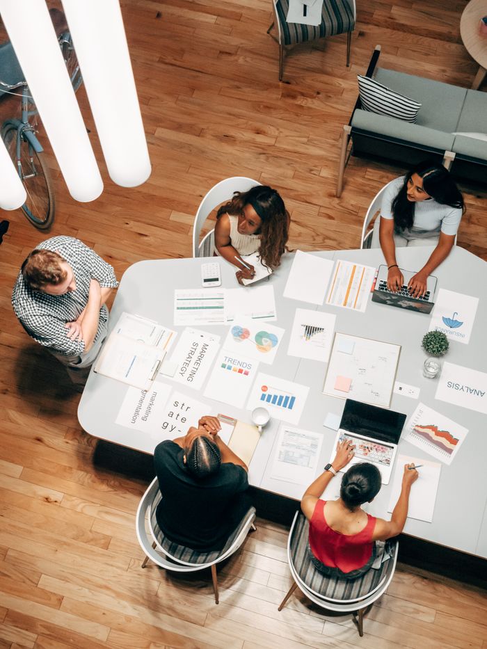 The Art of Drawing Readers In: Your attractive post title goes here High-angle view of diverse team collaborating on a business project in a modern office.